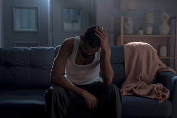 Depressed black man evokes sense of solitude and introspection in home setting