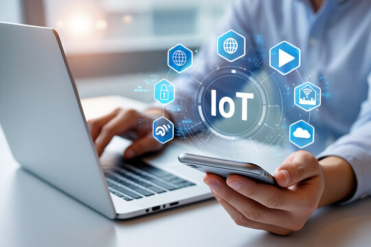 Person using laptop and smartphone with IoT technology interface