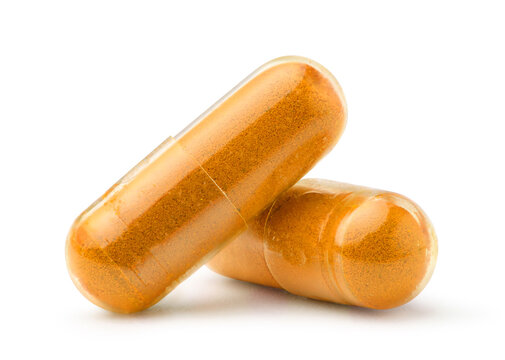 Turmeric capsules isolated on white. Clipping path.