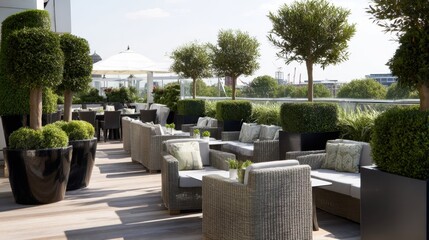 Outdoor terrace of a rooftop restaurant, decorated with potted plants and sleek seating