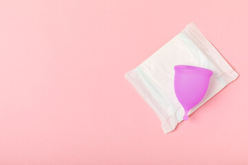 Menstrual cup on a bright background. Sanitary napkins, tampons and menstrual cup.Concept of...