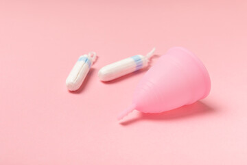 Menstrual cup on a bright background. Sanitary napkins, tampons and menstrual cup.Concept of...