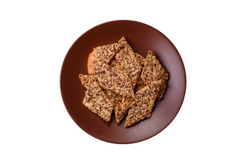 Crispbread, thin bread with seeds and grains, a baked cracker. Crispbread with sesame seeds