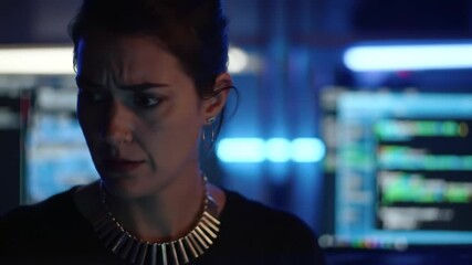 Focused cybersecurity analyst examining complex code on multiple screens - Powered by Adobe