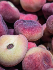 Vertical image of ripe flat peaches