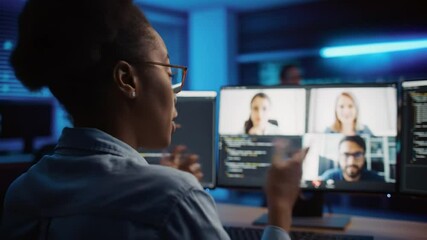 Modern tech worker participates in a virtual code review meeting from her home office - Powered by Adobe