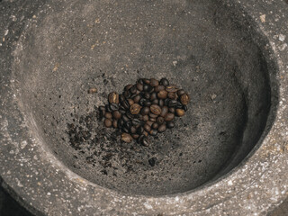 The traditional method of making ground coffee involves pounding roasted beans using a mortar and...
