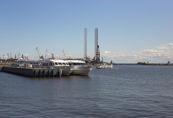Two motor boats are moored at the pier. The water is calm, the sky is clear, 07/24/2021 , Gulf of...