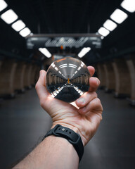 hand holding a lensball in prague subway