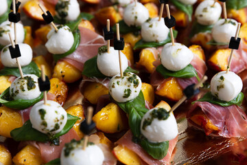 Peaches with mozzarella, prosciutto and basil