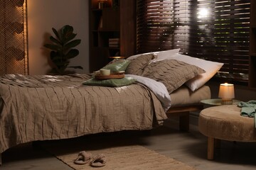 Comfortable bed with beautiful linens in bedroom