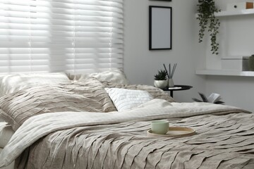 Comfortable bed with beautiful linens in bedroom