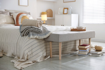 Comfortable bed with soft linens in room. Home textile