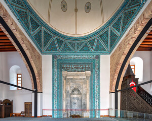 Beautiful architecture of Alaaddin Keykubad Mosque is highlighted by its detailed mihrab, reflecting the rich Islamic heritage in Konya, Turkey. The vibrant patterns enhance the spiritual environment