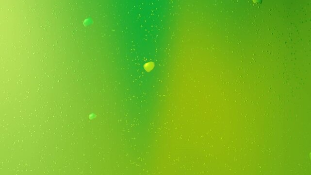 Green liquid with small yellow objects floating.