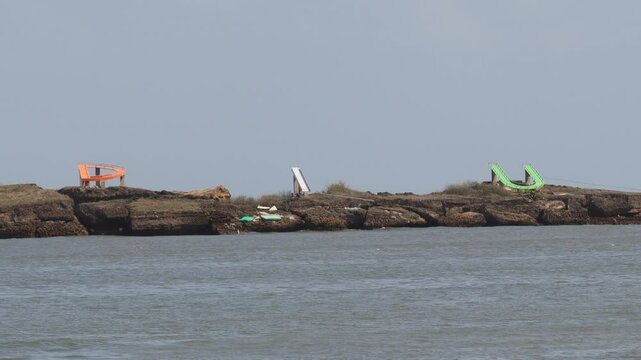 The blue water and with a sandy beach. wind blowing on DIU you written on nagoa beach. View of The Indian ocean and sand Nagaon beach with it's blue water in the distance at Diu, Gujarat, India.