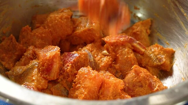 Boneless fish cubes getting marinated in Indian spices