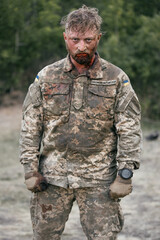 The face of a Ukrainian soldier in blood. A soldier after being wounded. A difficult scene...