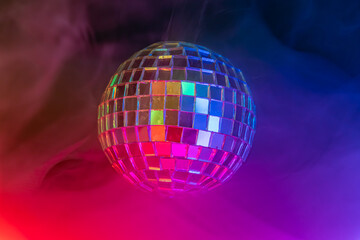 Disco ball in vibrant, colored light, reflecting hues, reminiscent of dance clubsparties, creating...