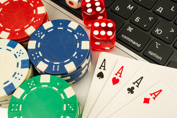Close-up of poker chips on gaming table, Ace of Spades visible, hinting at blackjack or poker, contemporary setting with computer keyboard in background, evoking themes of luck, strategy, and gamblin