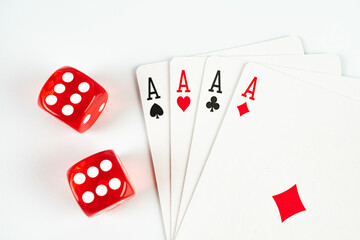 Image of two red six-sided dice and playing cards with A on them, suggestive of gambling or casino activities like poker and blackjack, for marketing materials in gaming, entertainment, or hospital
