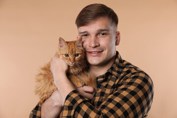 Man with cute ginger cat on beige background