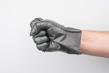 Close-up of black gloves, thick material, curled fist, indoor setting, neutral background, even...