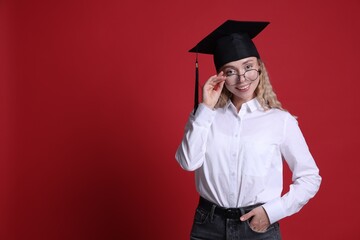 Happy student after graduation on red background. Space for text