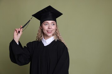Happy student after graduation on green background. Space for text