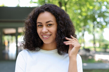 Portrait of smiling Latin American woman outdoors