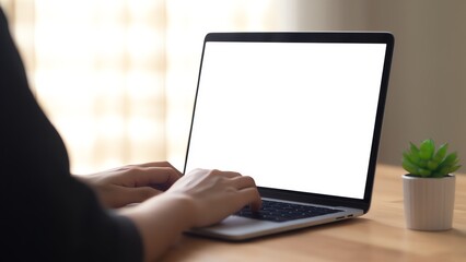 An image of a person working on a laptop with a blank white screen