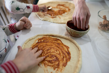 making homemade pizza at home in the kitchen