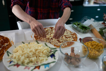 making homemade pizza at home in the kitchen