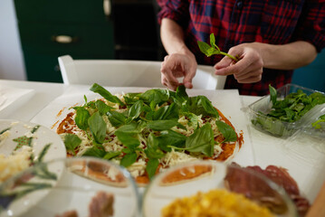 making homemade pizza at home in the kitchen