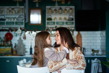 portrait of mother with daughter at home, cute and cozy photo