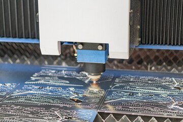 Close-up view of industrial laser, robotic arm in motion installingremoving component from circuit board on conveyor system Circuit boards have intricate patterns and multicolored components Clean