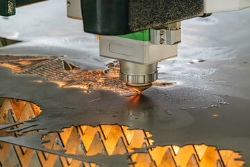 Close-up view of an industrial process involving molten metal being filled into a circular plate using a CNC machine tool, with a factory setting background and artificial lighting