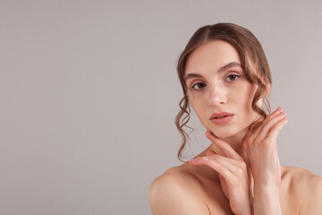 Naklejka premium Portrait of attractive young woman on light grey background. Space for text