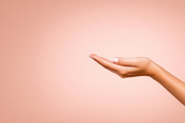 A close-up of a perfectly manicured hand with natural nails held out against a soft peach background.