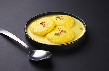 Indian dessert called rasmalai is also known as rich cheesecake without crust. serve in plate isolated on black background 
