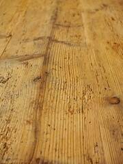 The wooden floor has a grainy texture and is slightly worn