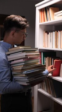 vertical video Librarian organizing books in library bookshelf