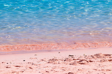 Amazing view of pink beach at Komodo Island, Indonesia. Close-up photo of pink sands with waves and...