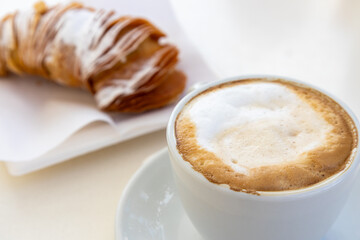 Coffee with milk and an Italian cornet.