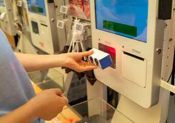 Women purchase food at self-service shopping machines