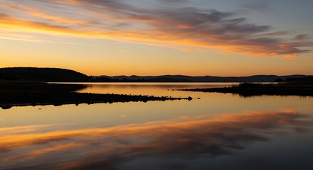 Obraz premium Serene Sunset over Calm Lake with Stunning Sky Reflection