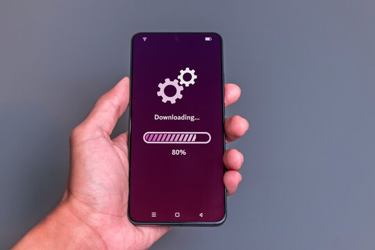 Downloading process bar on phone screen. Man using smartphone to download media or update software.