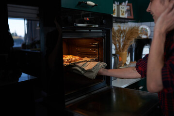 making homemade pizza at home in the kitchen