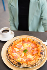 Businessman ready to eat Hawaiian pizza with pineapple and ham