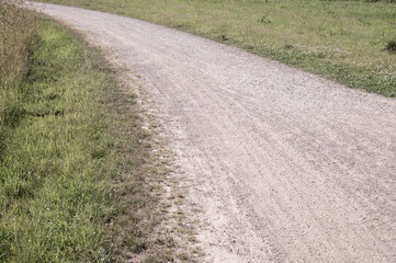 Winding gravel path through green fields invites exploration on foot